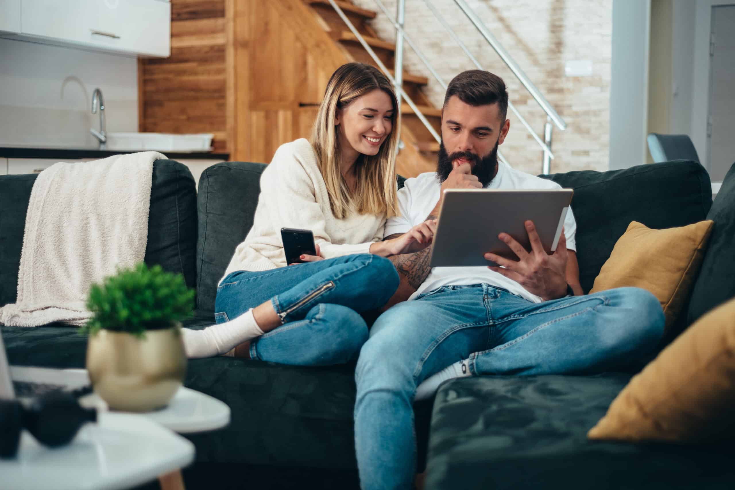 Couple searching on a tablet comparing options.