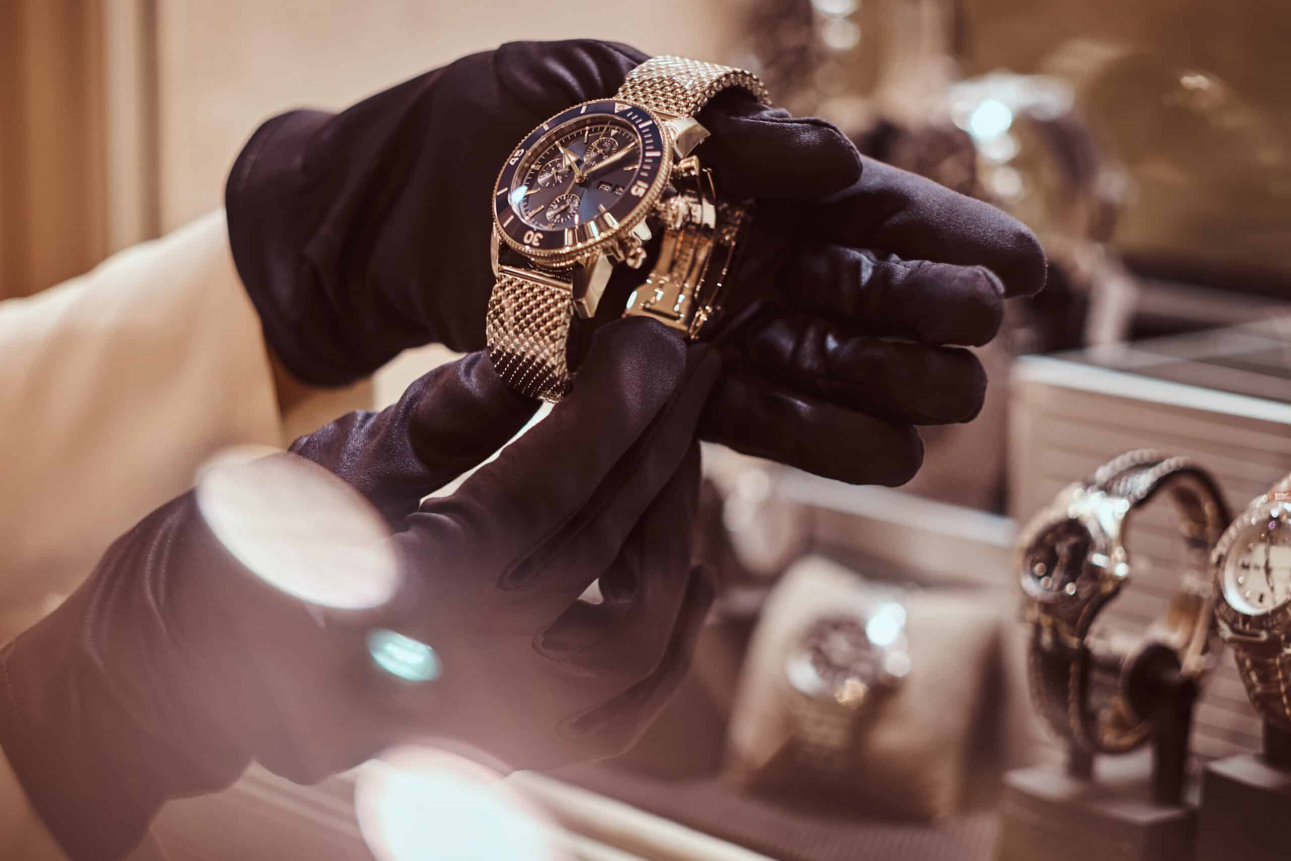 Luxury watch handled by gloved salesperson
